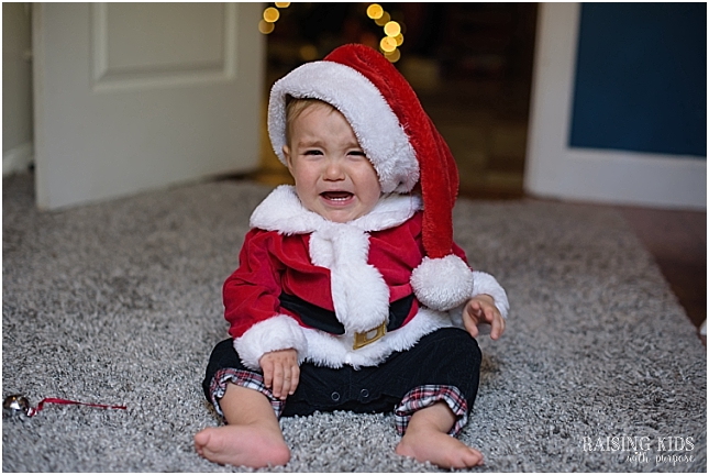 anxious baby at christmas santa suit