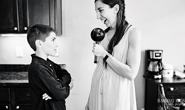 mom speaking into microphone to son