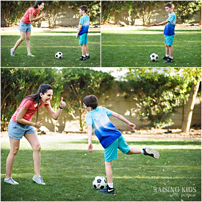 mom and son playing soccer in backyard
