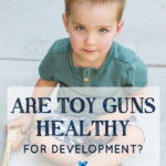 toddler boy with toy gun