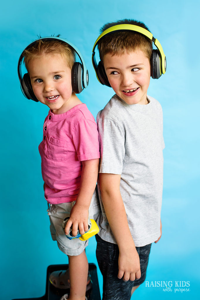 brothers with wireless headphones