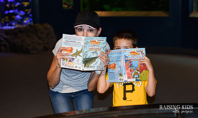 mom and son at aquarium with books spending quality time together