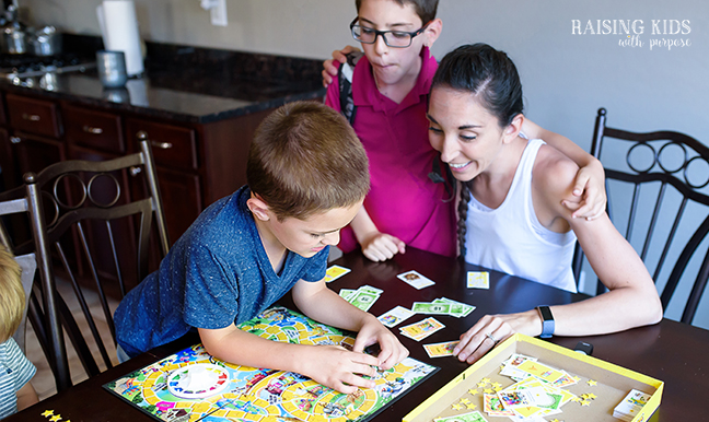mom and sons playing the Game of Life Junior