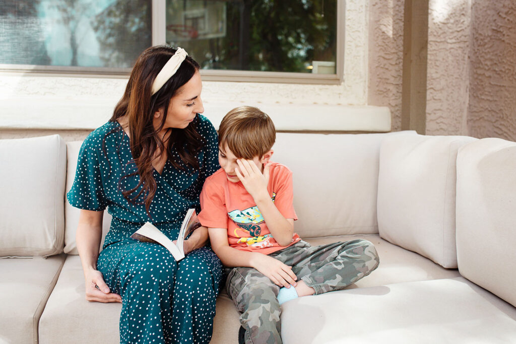 mom reading and teaching emotions to child on backporch in Arizona