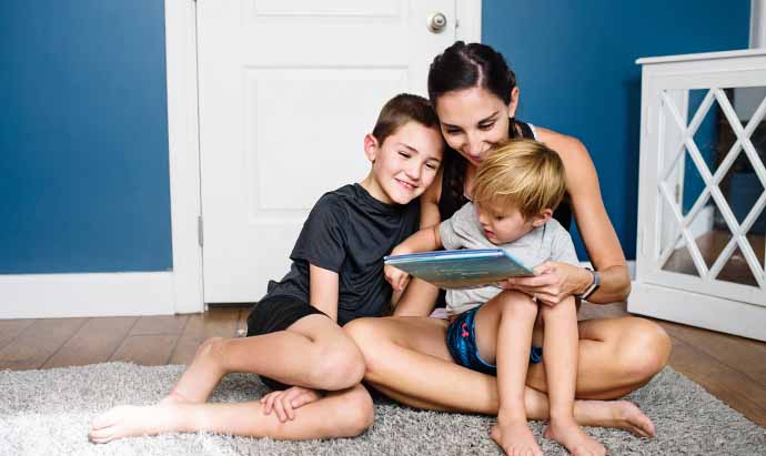 mom and sons reading books together by BookRoo