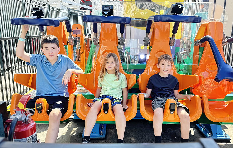 boys riding a ride at Belmont Park in San Diego