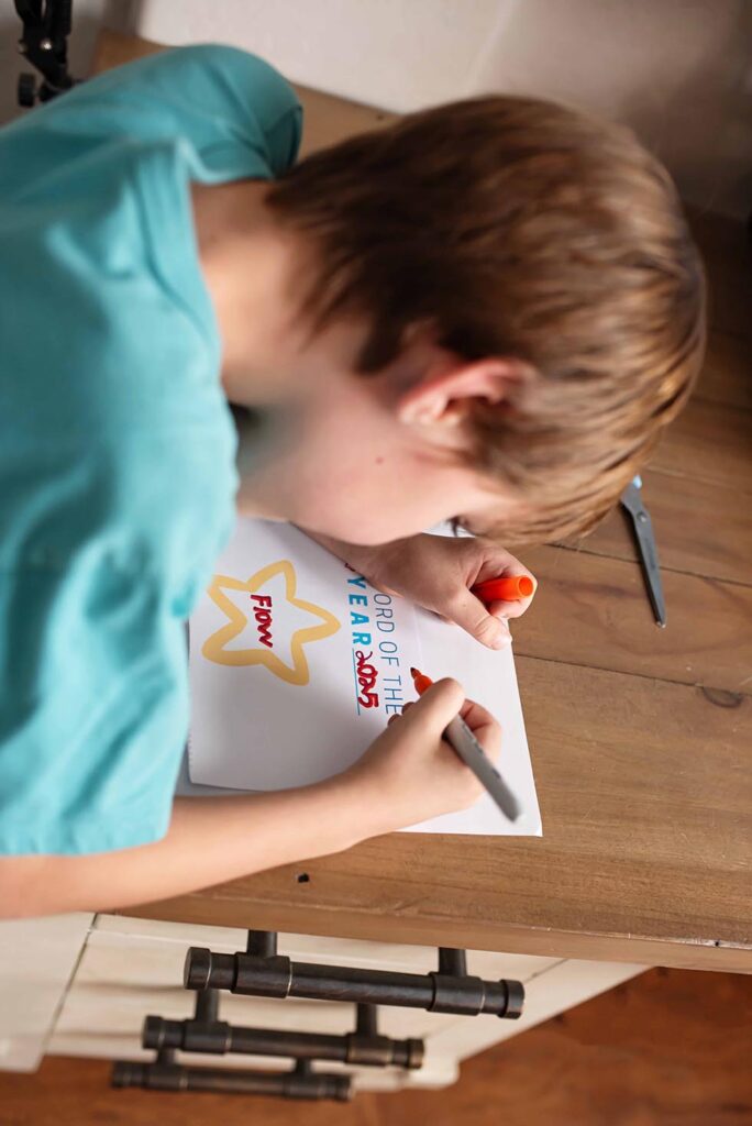 boy writing his goal down for the year