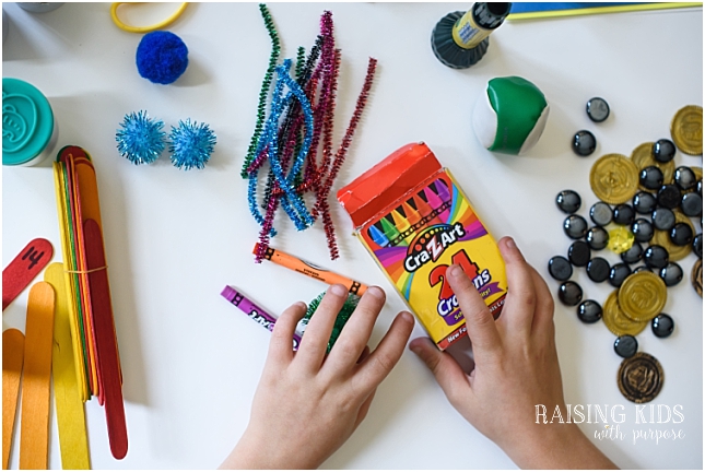 boy holding crayons