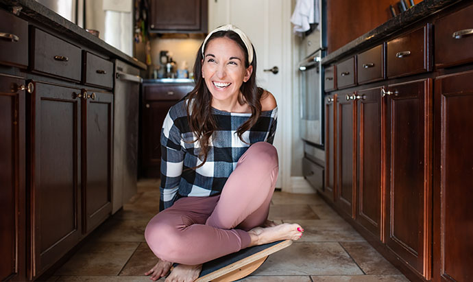 mom on balance board in kitchen