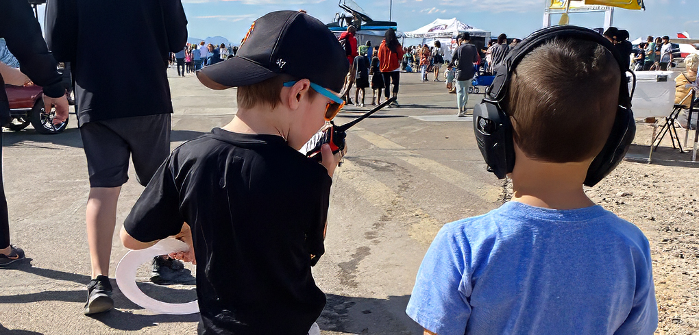 two boys in a crowd at an air show in Buckeye, AZ