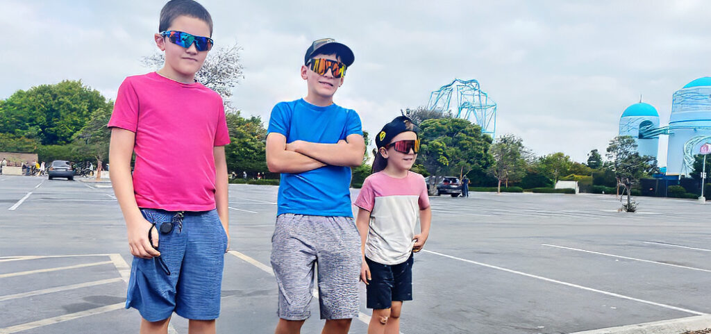 three brothers standing in the Sea World Parking lot