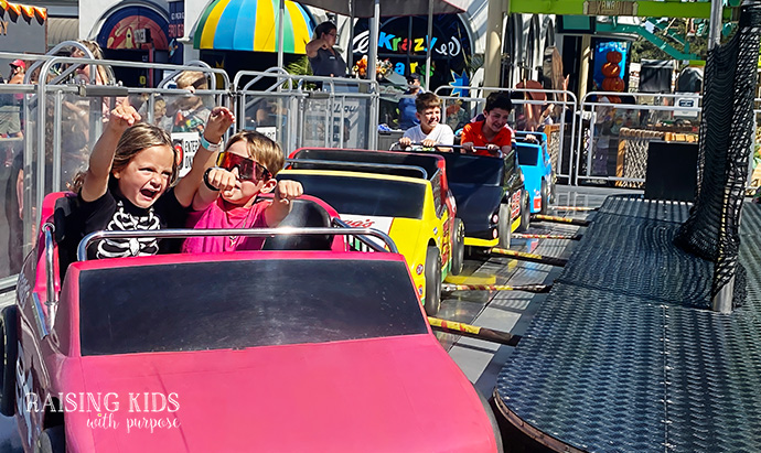 boys riding on a car at Belmont park