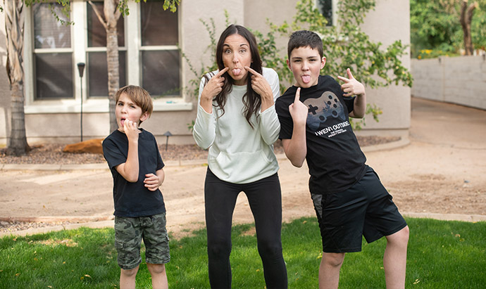 mom and boys sticking tongues out