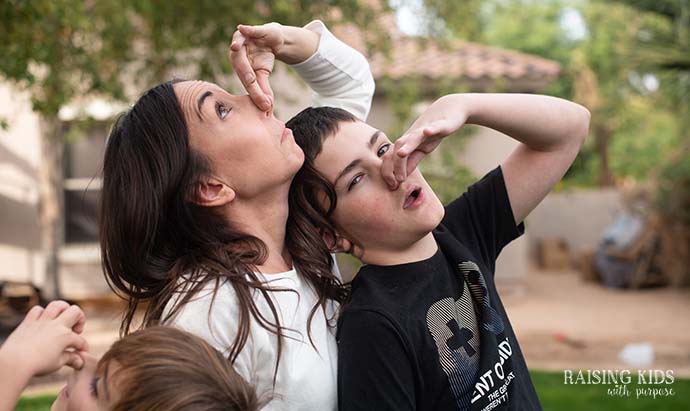 mom and boys holding their noses