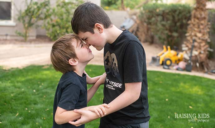 brothers with their noses touching