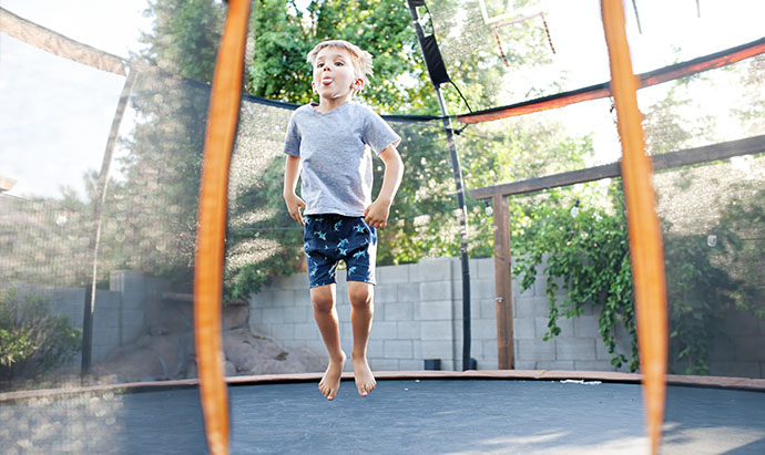 boy jumping on trampoline