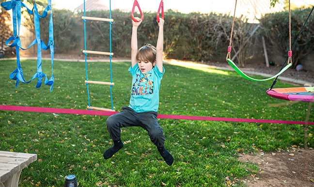 boy swinging on rings