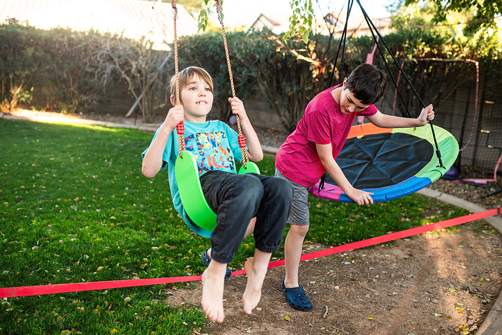 boys swinging on slack line