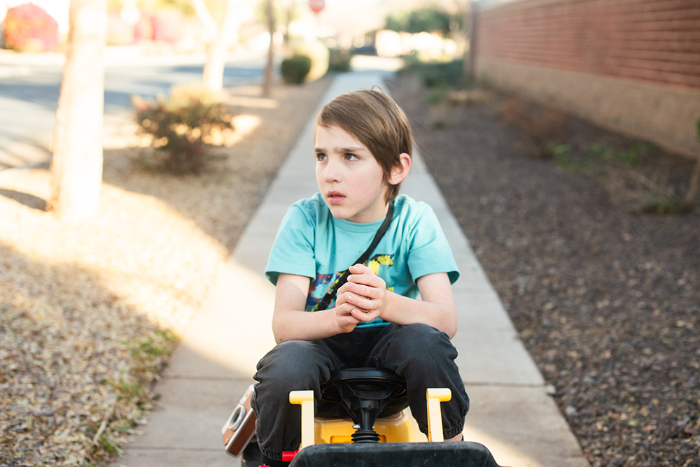 neurodivergent boy sitting on tractor