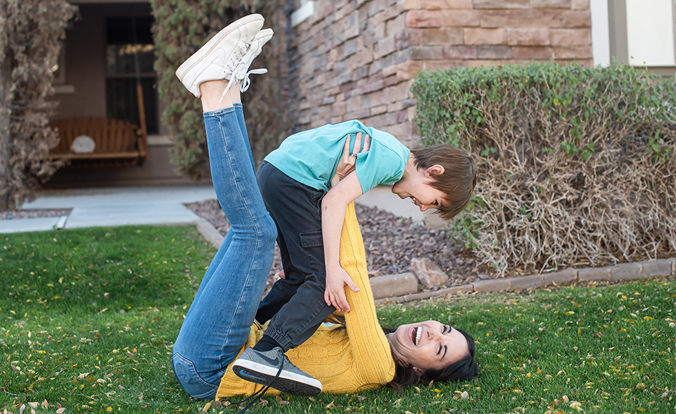 mom holding son up