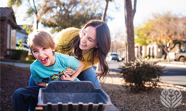 mom and son laughing on toy tractor