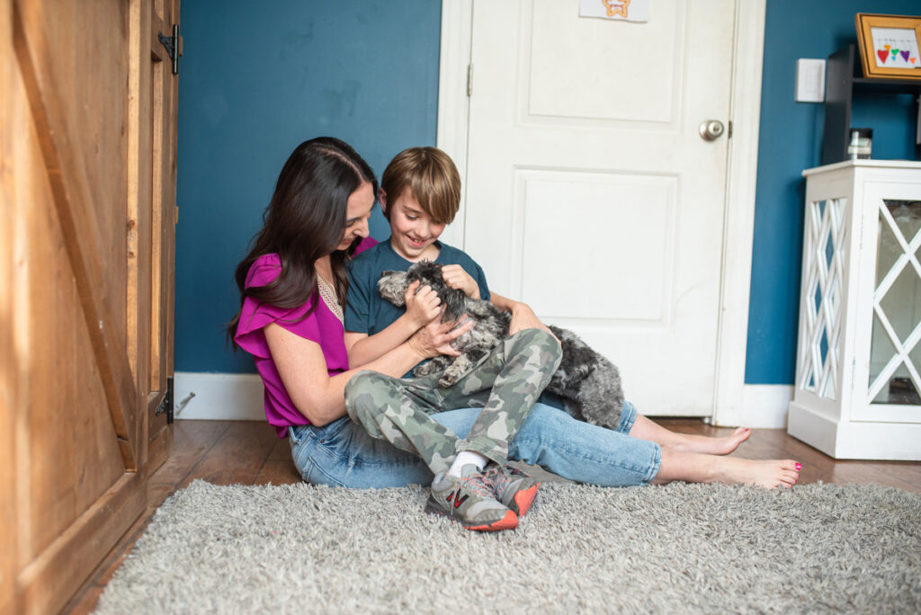 mom, son and Aussie doodle puppy hugging