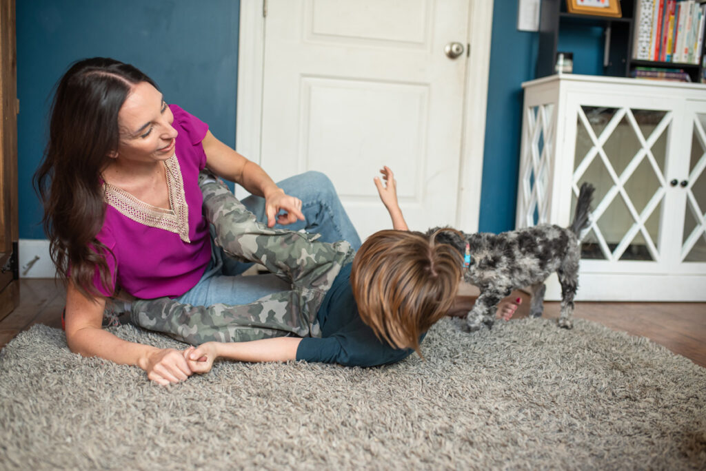 mom and son on floor wrestling