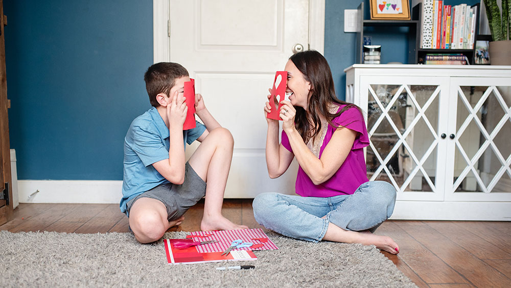 mom and son making Valentine's gift together