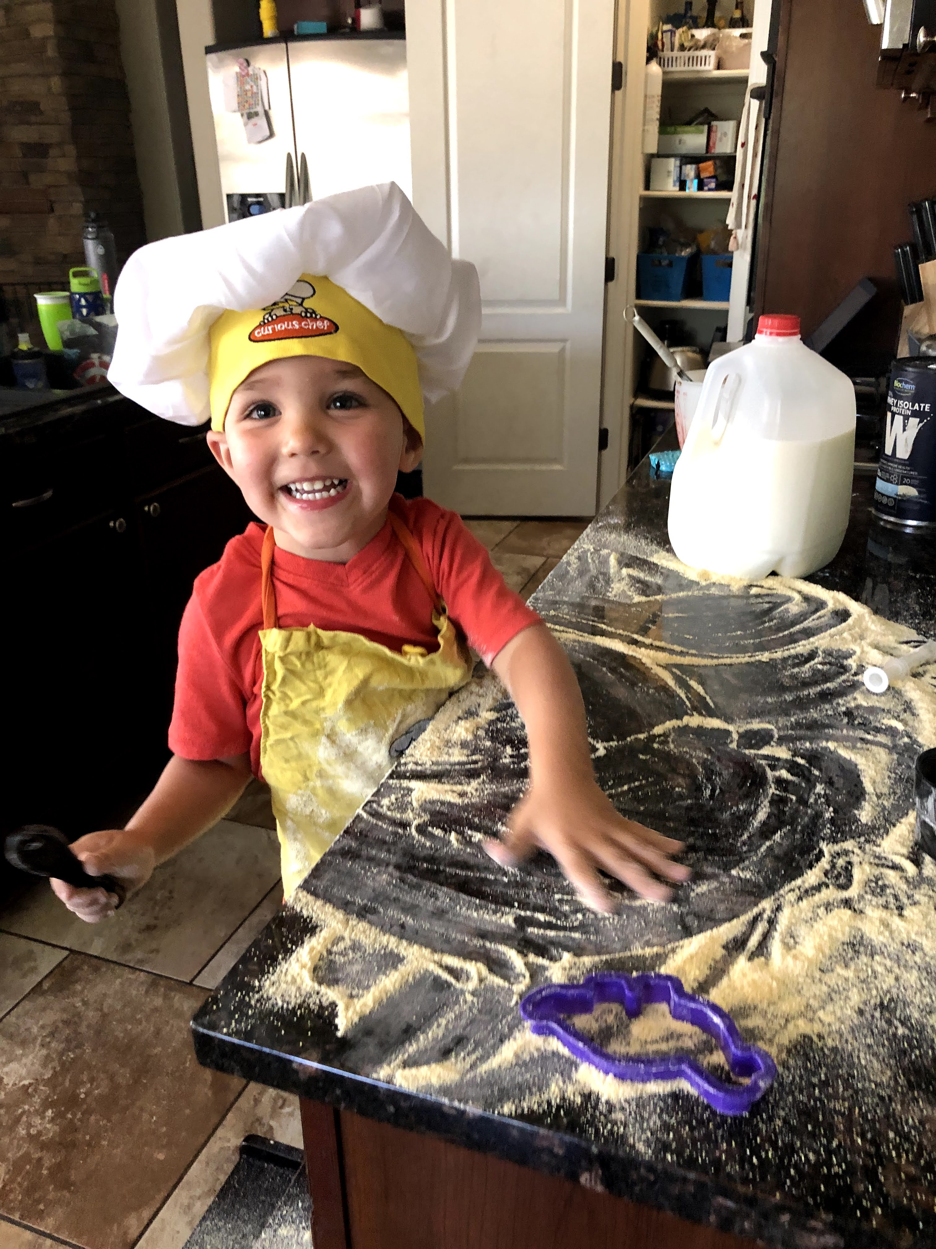 toddler boy making family dinner