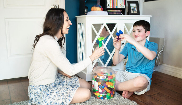 mom and son playing with math cubes for and activity from a coping skills list