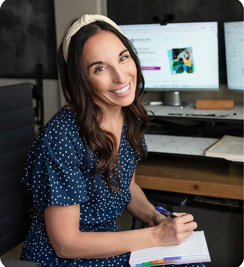 Adriane thompson sitting in front of desk with her parent coaching program on the computer screen