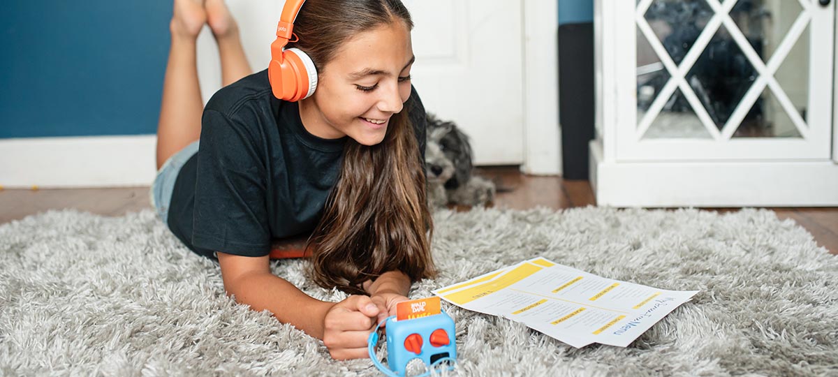 little girl following her summer screen time rules using a Yoto player