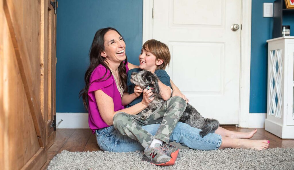 playful mom with son and dog