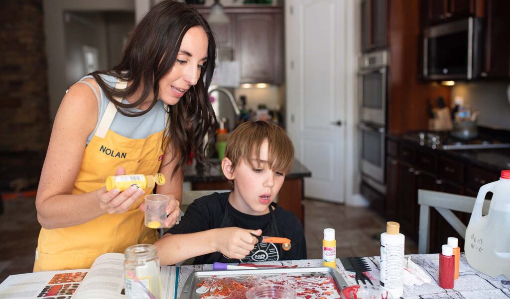 mom and son paint marbling while mom holds firm boundaries
